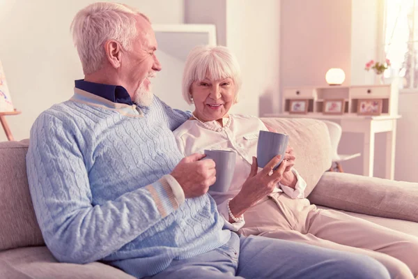 Senior cheerful man hugging his smiling wife