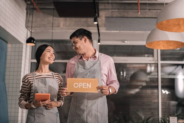 Appealing wife feeling happy opening new restaurant with her man