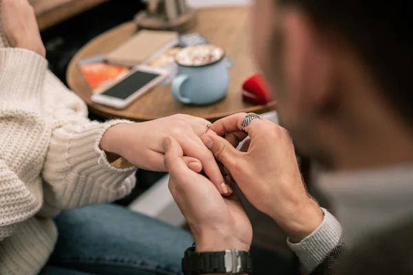 Man putting a ring on his girlfriends finger — Stock Photo, Image