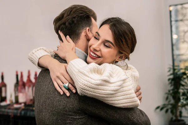 Impressed and happy woman hugging her husband — Stock Photo, Image