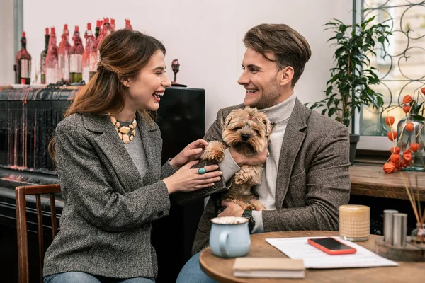 Happy family with a dog. The young family is joking about their dog