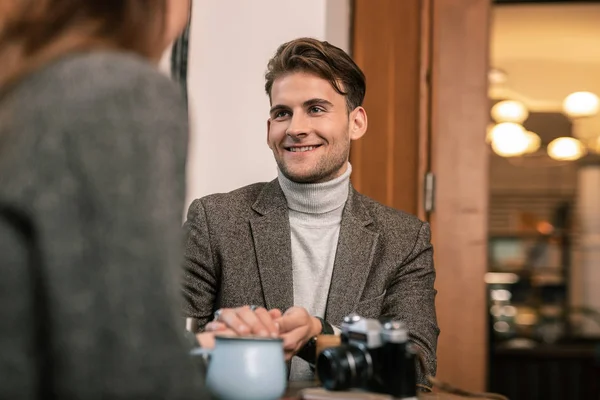 Hombre sonriente hablando con la mujer en el café — Foto de Stock