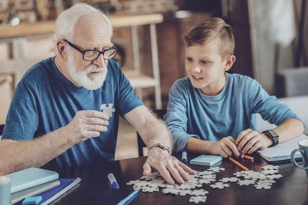 Attentive granddad playing with his grandson — Stock Photo, Image