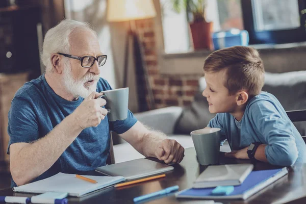 Hot Tea Pleased Kind Boy Expressing Positivity Looking His Grandfather — Stock Photo, Image