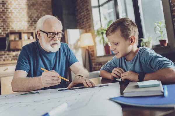 Positive delighted boy listening to his granddad — Stock Photo, Image