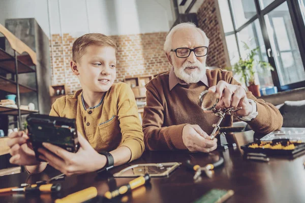 Cheerful boy looking at his granddad — Stock Photo, Image