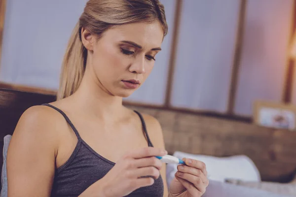 Pleasant young woman checking thermometer — Stock Photo, Image