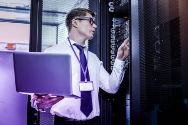 Ciddi yakışıklı genç adam onun laptop holding