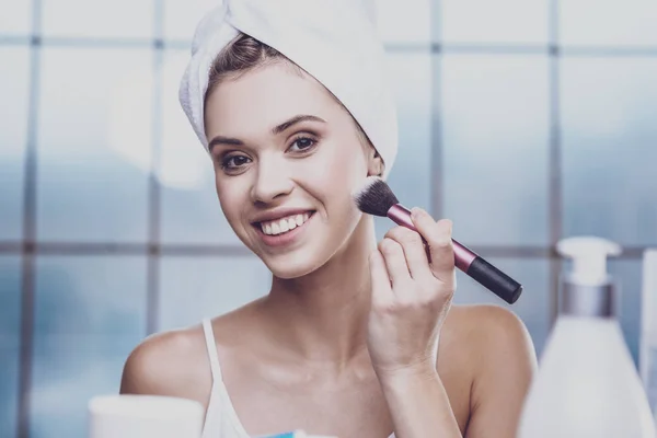 Pleasant young woman applying cosmetics — Stock Photo, Image