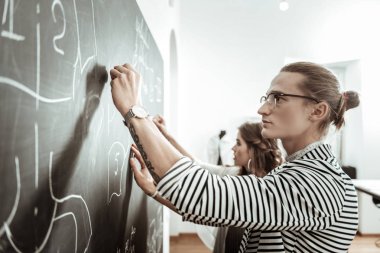 Yakışıklı genç terzi gözlük ve skeçler bir tahtada çizim güzel bir model