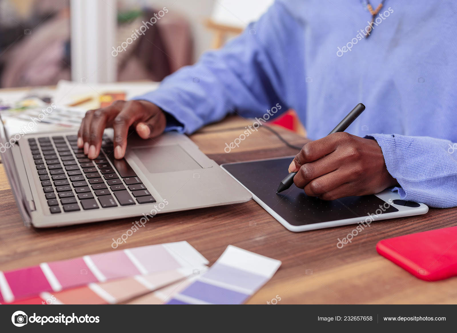 Close Up Fashion Designer Using Little Smart Board And Laptop