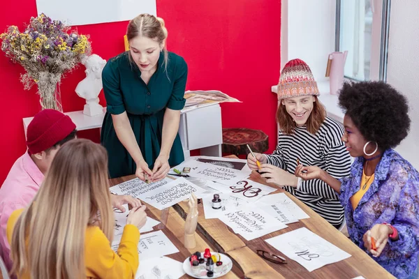 Teacher of art feeling busy while teaching her students