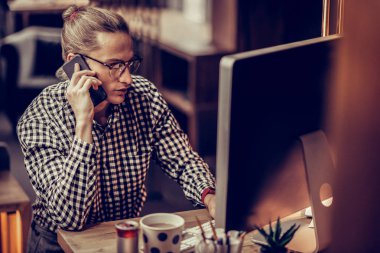 Ofiste olurken telefon konuşan ciddi adam