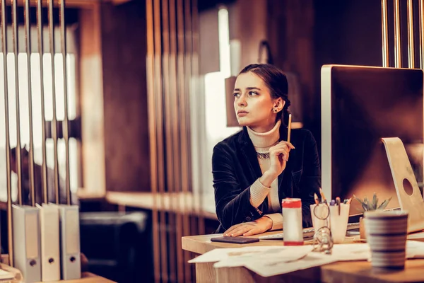 Amazing brunette woman sitting at her workplace — Stock Photo, Image