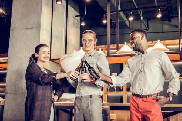 Positive delighted young colleagues having welcoming party — Stock Photo, Image