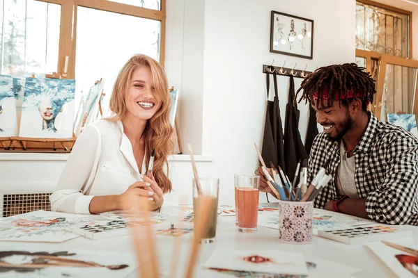 Beautiful girlfriend laughing while drawing with her man