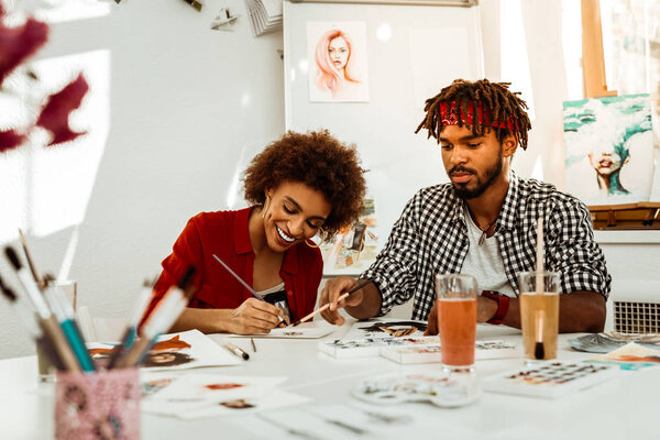 Couple of inspired art student feeling good painting together
