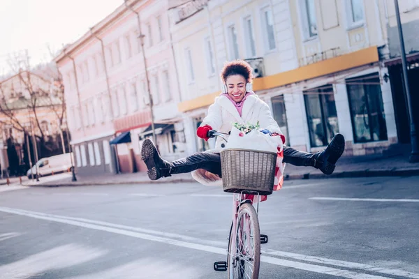 Позитивная брюнетка, сидящая на велосипеде — стоковое фото