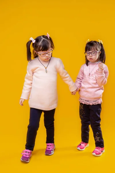 Dark-haired pretty girls with down syndrome and unusual face features — Stock Photo, Image