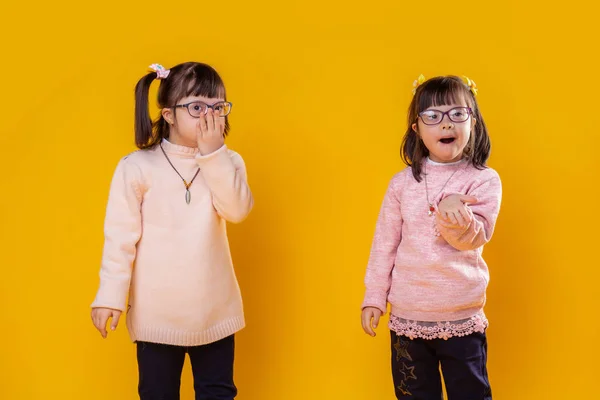 Little pretty girls with mental disorder wearing pink sweaters — Stock Photo, Image
