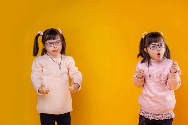 Active young children with mental disorder having same hairstyle — Stock Photo, Image