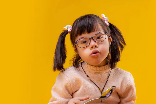Любопытная маленькая забавная девочка с большой металлической ложкой — стоковое фото