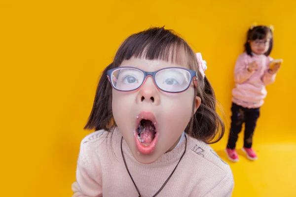 Dark-haired girl with down syndrome opening her mouth — Stock Photo, Image