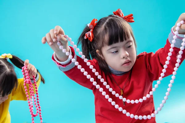 Attentive girl with mental disorder dealing with decorative beading — Stock Photo, Image