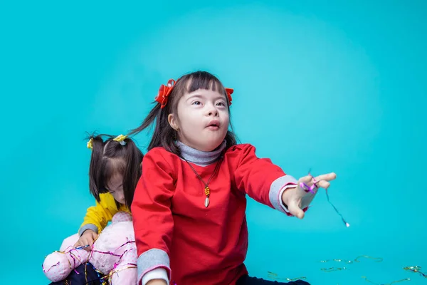 Two twin sisters having great time together while sitting in studio — Stock Photo, Image