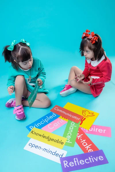 Short-haired little girls spending time together while sitting on floor — Stock Photo, Image