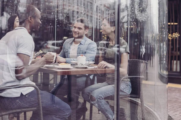 Double exposure of delighted friends that being in cafe — Stock Photo, Image