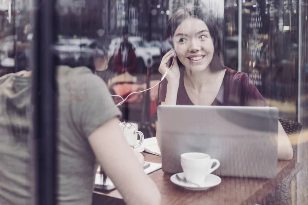 Pleased international girl wearing earphone — Stock Photo, Image