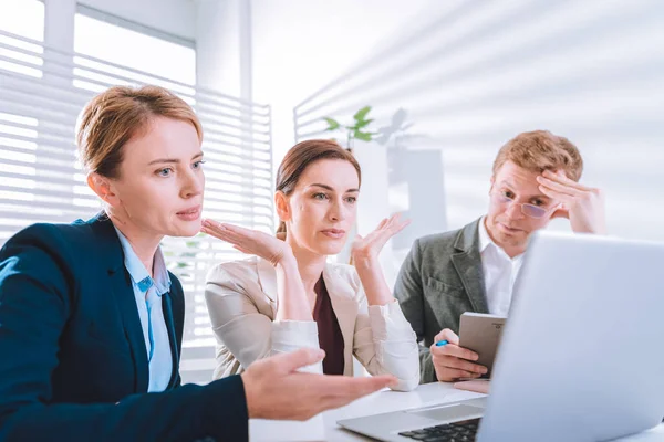 Serious agradable colegas mirando la pantalla del ordenador portátil — Foto de Stock