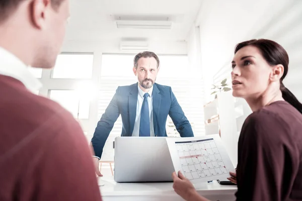 Focused three colleagues facing trouble