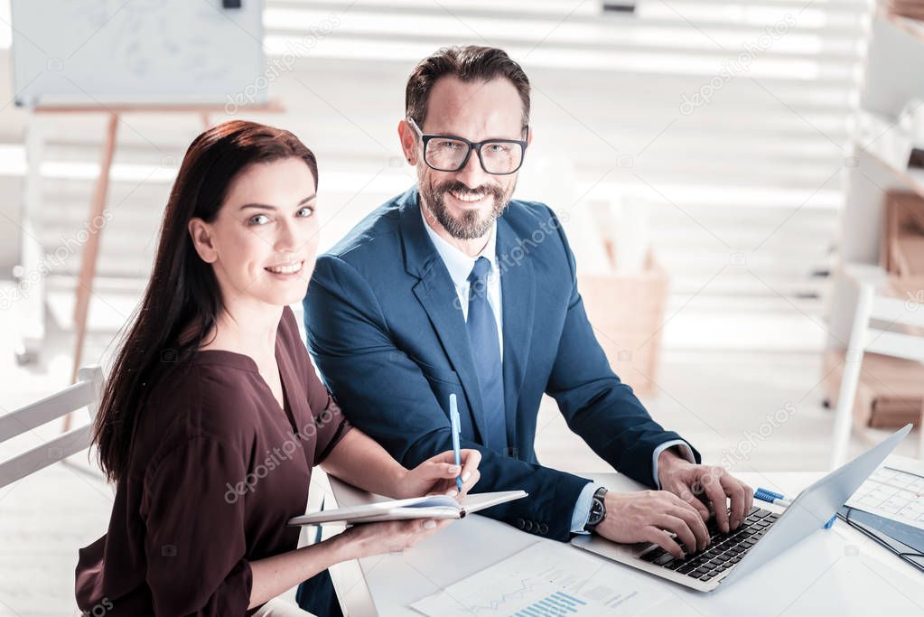 Cheerful two colleagues planning business trip