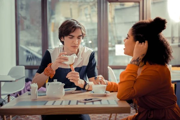 Boy and a girl drinking tea in the cafe