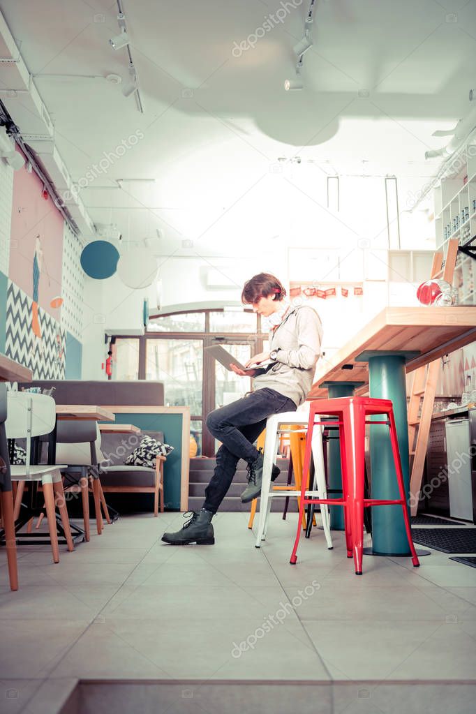 Free wi-fi. The teenager using free wi-fi in the cafe