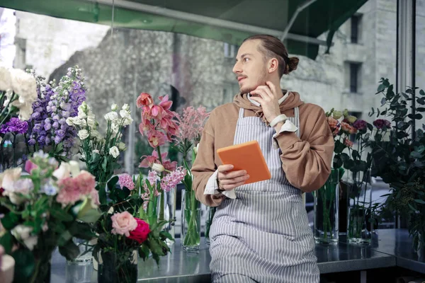 Cheerful blonde male person holding tablet in hand — Zdjęcie stockowe