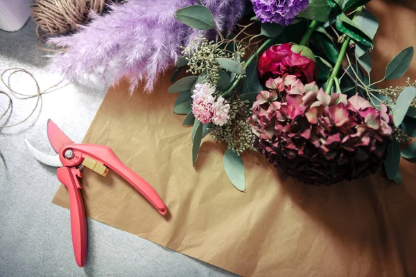 Close up of flowers that lying on craft paper — Stok fotoğraf