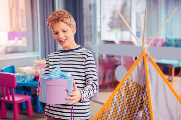 Positive delighted boy looking at gift box — Stock Photo, Image