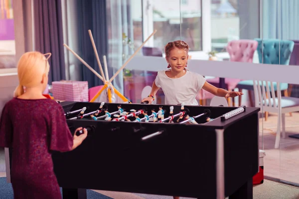 Two pretty girls playing table game together — Stock Photo, Image