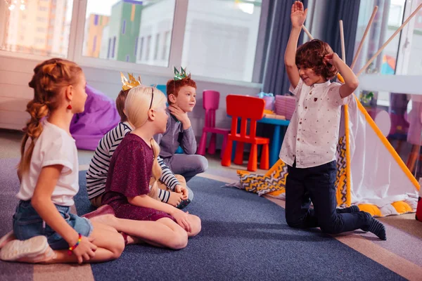 Positive delighted children looking at their friend — Stock Photo, Image