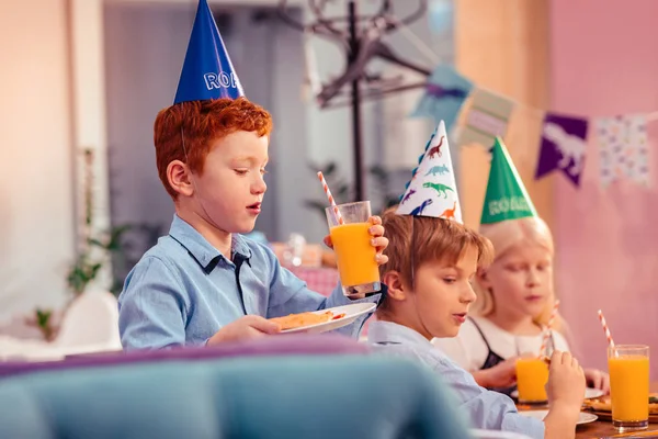 Attentive teenager looking at his food on plate — Stock Photo, Image