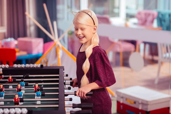 सकारात्मक प्रसन्न सुनहरे बालों वाली लड़की टेबल गेम खेल रही — स्टॉक फ़ोटो, इमेज