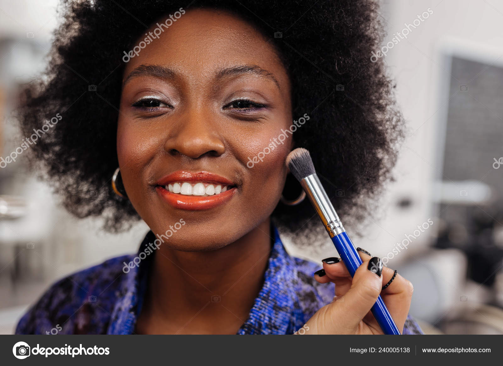 Pretty smiling dark-skinned model in an orange top looking amused Stock Photo by ©Dmyrto_Z 240005138 Pretty smiling dark-skinned model in an orange top looking amused Stock Photo by ©Dmyrto_Z 240005138