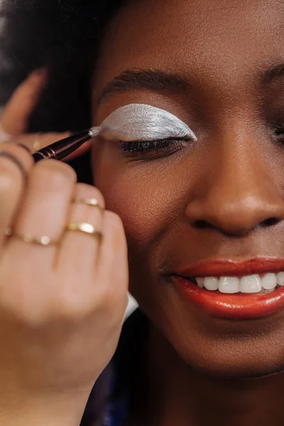 Amazing african american model with coral lipstick looking amused