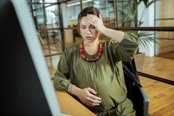 Young pregnant woman having headache after working on computer — Stock Photo, Image