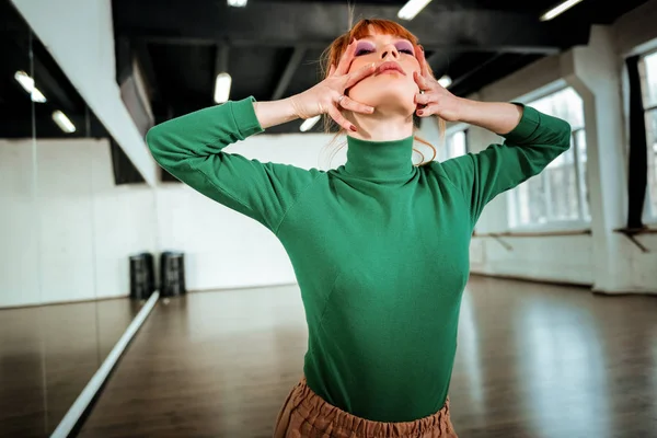 Young red-haired dance teacher with bright makeup looking dramatic — Stock Photo, Image