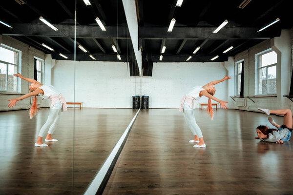 Blond teenager from generation z in white clothing doing back leaning