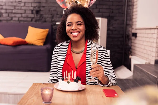 Delighted nice young woman celebrating her birthday